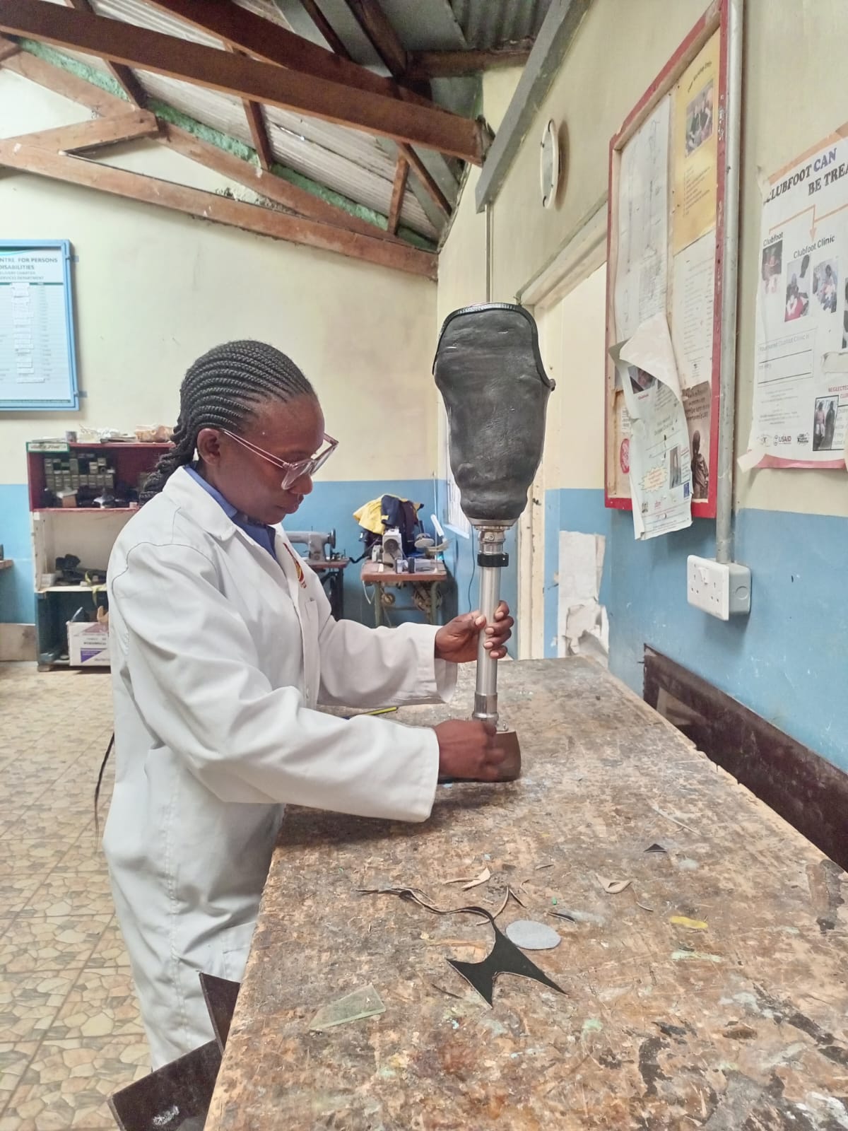 Orthopaedic technologist aligning a prosthetic limb