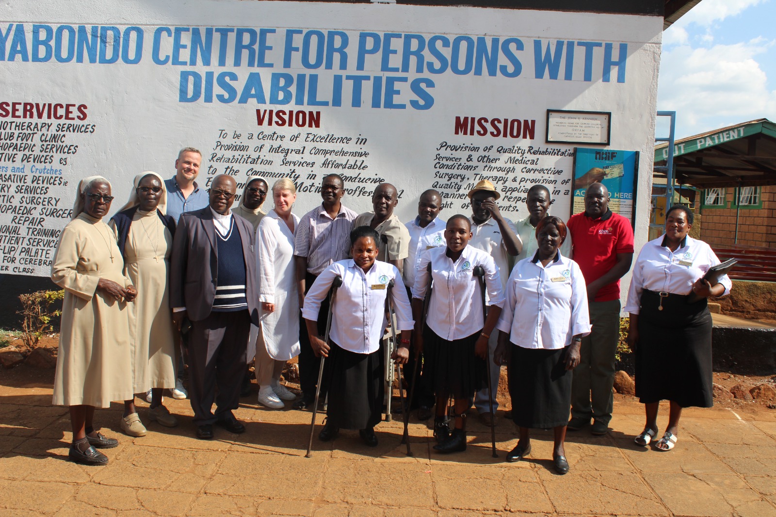 Nyabondo staff members with visitors from CBM.