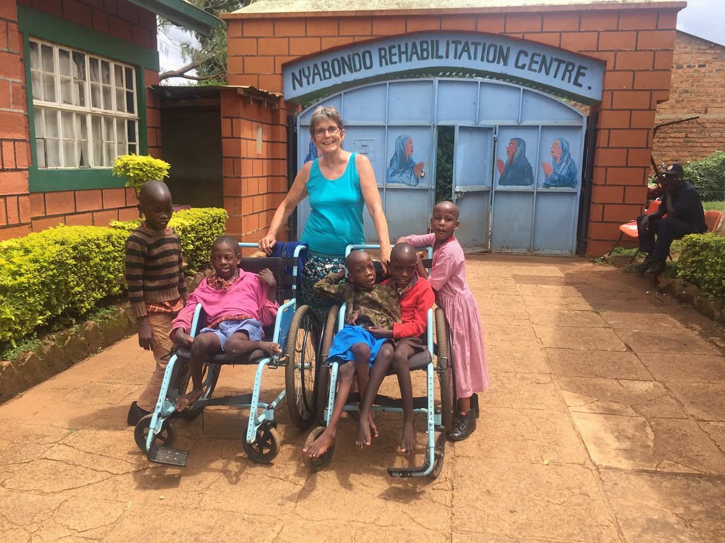A therapist guiding a patient through rehabilitation at Nyabondo Centre