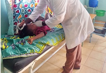 A physiotherapist working with a child during a therapy session
